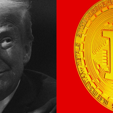 Photo of Donald Trump looking at an oversized bitcoin.