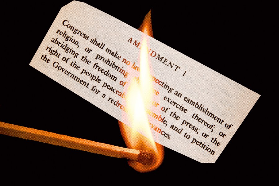 Photo illustration of a match lighting a slip of paper with the First Amendment 