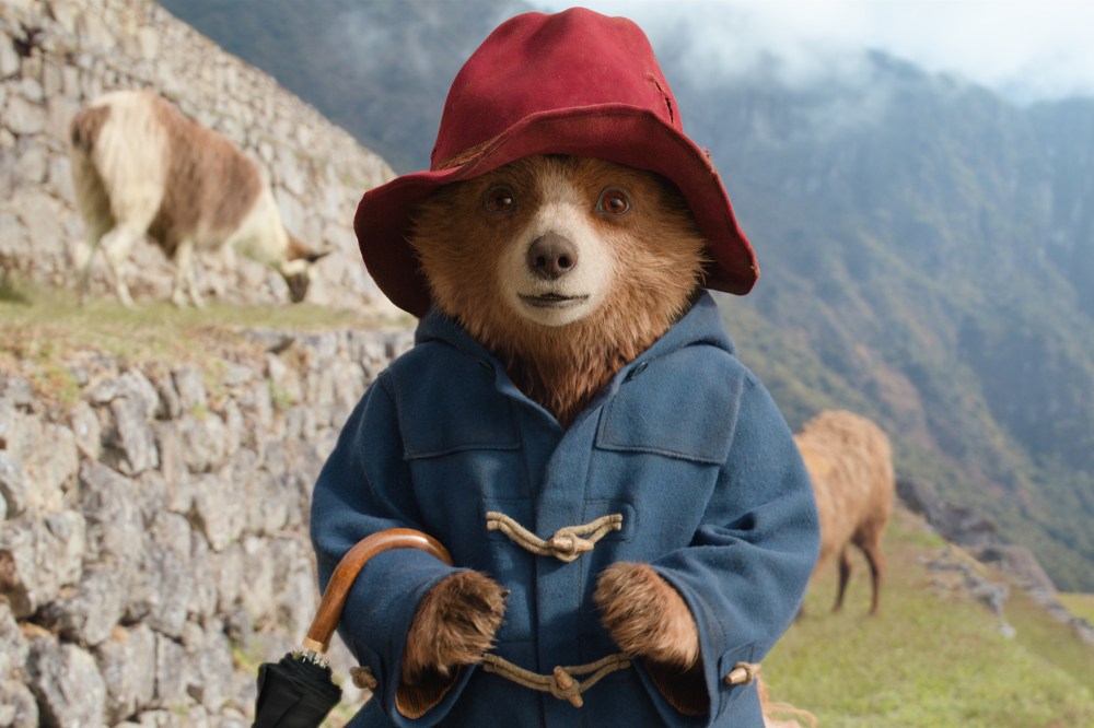 A 3D-animated bear wearing a blue peacoat and red hat outside