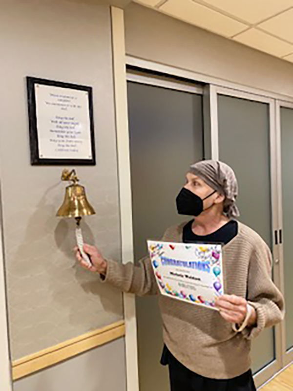 Michele Weldon rings the bell at the end of her cancer treatment. 