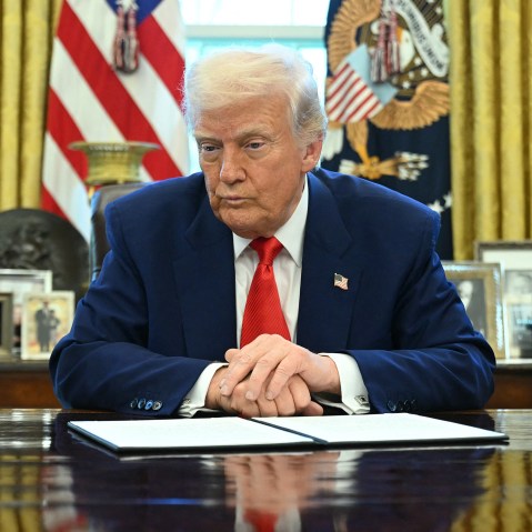 President Donald Trump prepares to sign an executive order in the Oval Office