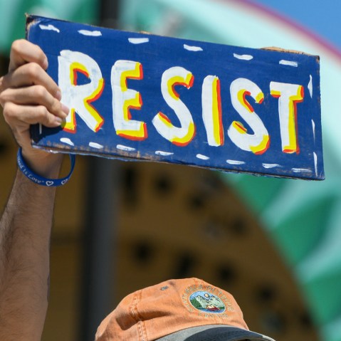 Ali Velshi and a protest sign.