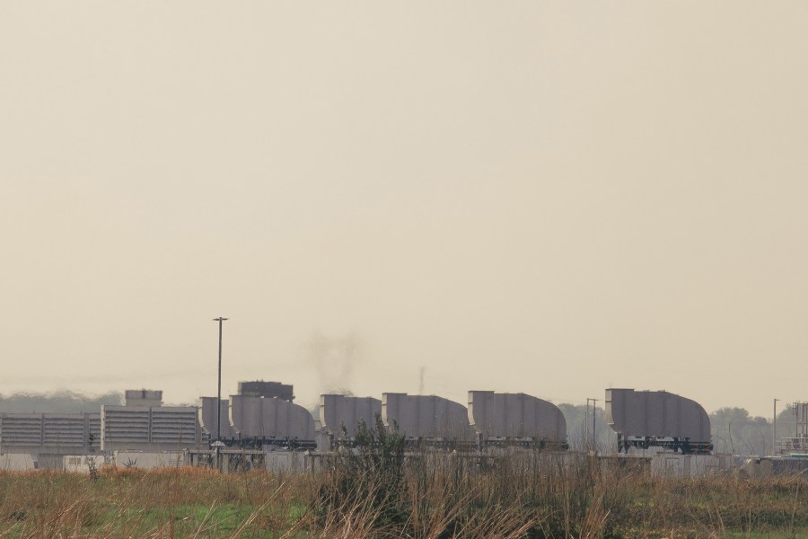 Gas turbines are seen in the distance outside