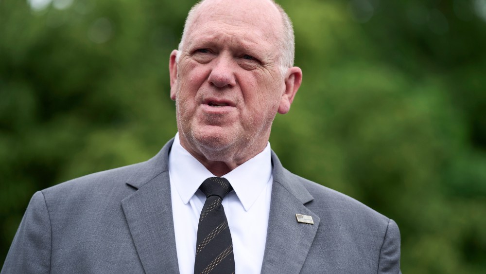 Tom Homan speaks while standing outside