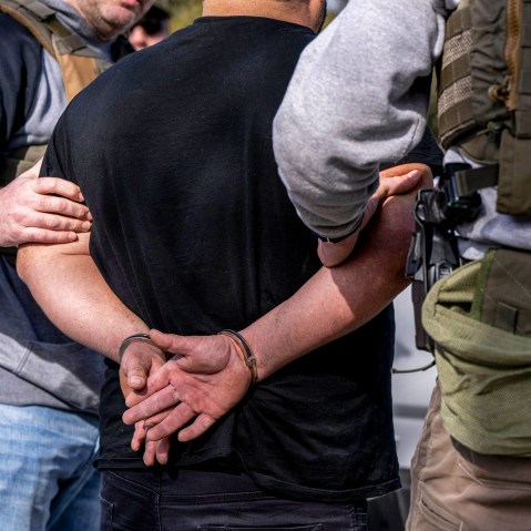 ICE agents carry out raid.