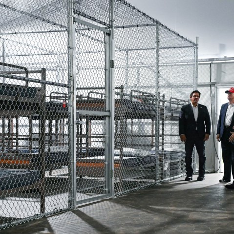 President Donald Trump, Florida Governor Ron DeSantis and Secretary of Homeland Security Kristi Noem tour a migrant detention center, dubbed "Alligator Alcatraz,