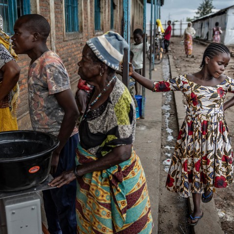 Refugees waiting in line for food.