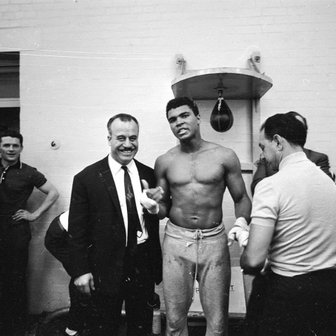 World heavyweight boxing champion Muhammad Ali has his hands bandaged by his manager Angelo Dundee before the day's training session at the Territorial Army Gymnasium at White City, London on May 16, 1966. (R. McPhedran/Express/Getty)