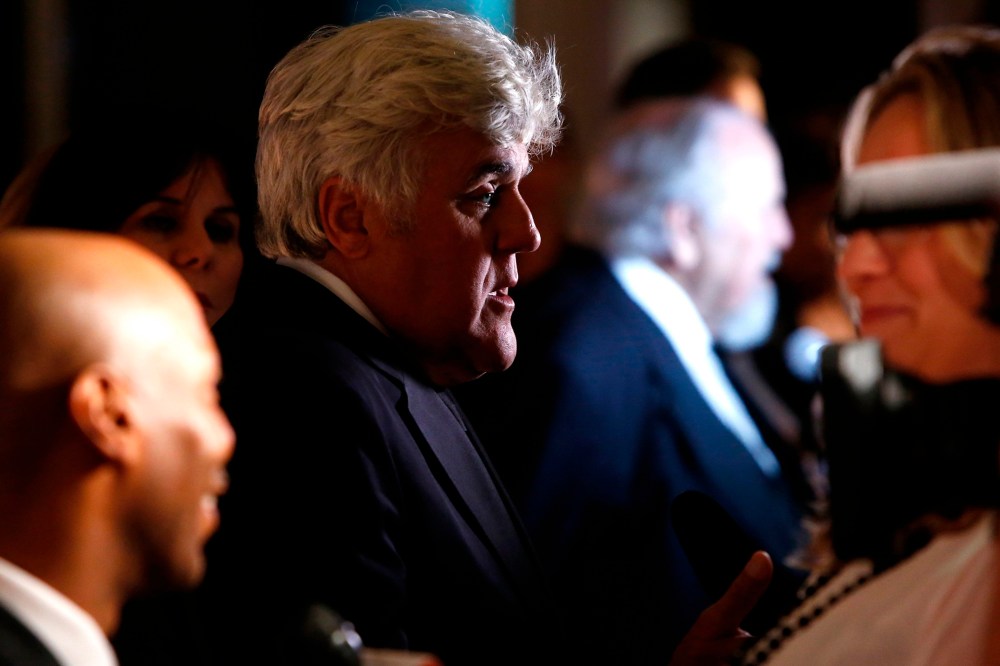 Honoree Jay Leno talks to reporters on the red carpet for the taping of the Mark Twain Prize for Humor ceremony and performance at the Kennedy Center in Washington on Oct. 19, 2014.