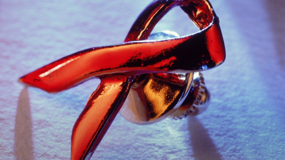 An AIDS awareness ribbon rests. (Photo by Christian Schmidt/Corbis)