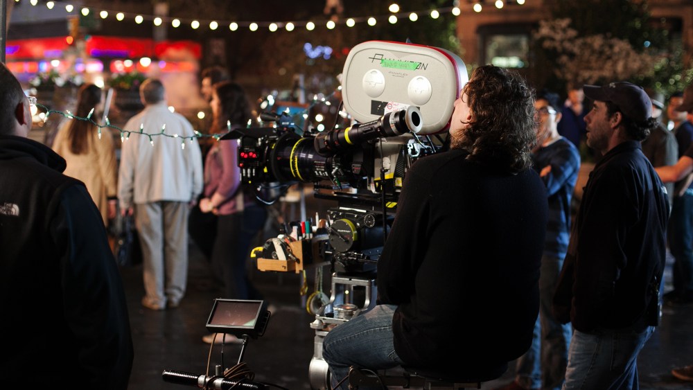 A camera operator prepares with his team and extras to film on location at Union Square, New York City, April 16, 2013. (Photo by Daniel Leal-Olivas/Corbis)