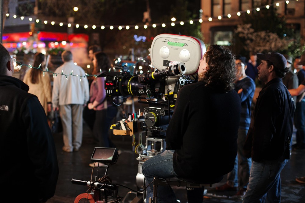A camera operator prepares with his team and extras to film on location at Union Square, New York City, April 16, 2013. (Photo by Daniel Leal-Olivas/Corbis)