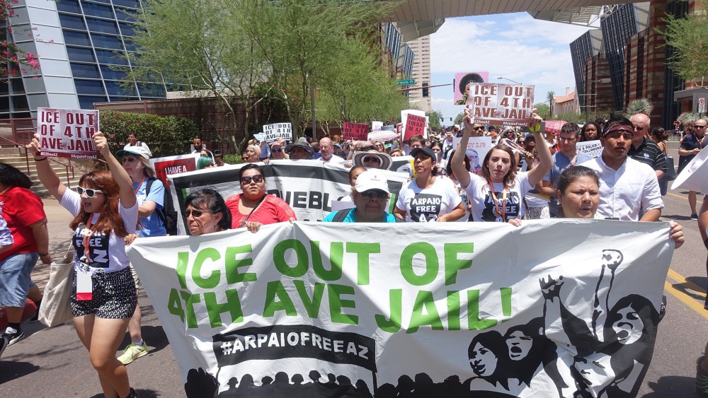 People attending the Netroots Nation march begin a half mile march in the heat behind a 'Ice out of 4th Ave jail!' banner to protest Sheriff Joe Arpaio's immigration policies on July 17, 2015. (Photo by Steve Rhodes/Demotix/Corbis)