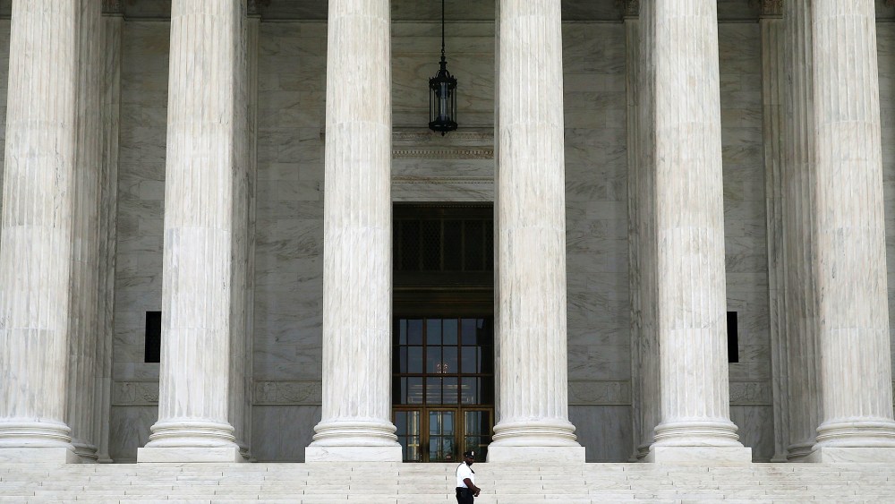 A guard stands outside the U.S. Supreme Court , on June 9, 2014 in Washington, DC.