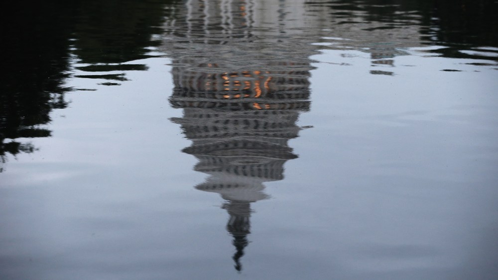 The U.S. Capitol is reflected in water on the morning of June 11, 2014 in Washington, DC.