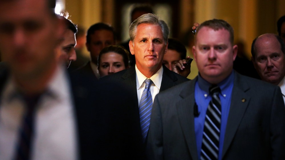 U.S. House Majority Whip Rep. Kevin McCarthy (R-CA) (C) passes through the Statuary Hall of the Capitol after a vote on the House floor, June 11, 2014.