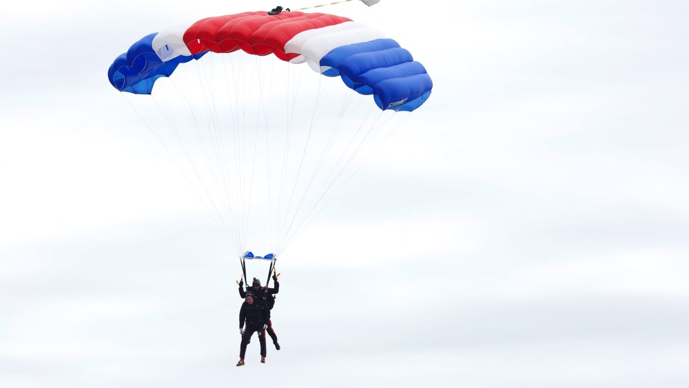 Former U.S. President George H.W. Bush and Mike Elliott, US Army Sergeant 1st Class (ret), jump out of a helicopter and parachutes down to St. Anne's Episcopal Church on June 12, 2014 in Kennebunkport, Maine.