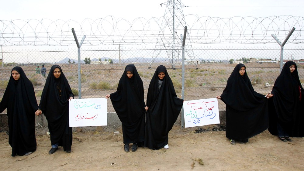 Iranian students form a human chain during a protest to defend their country's nuclear program outside the Fordo Uranium Conversion Facility in Qom, Nov. 19, 2013.