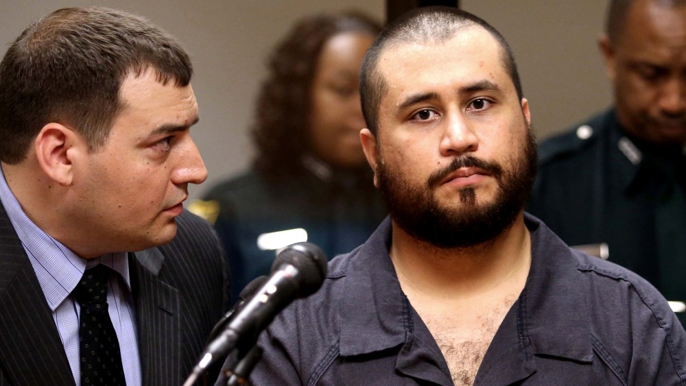 George Zimmerman, the acquitted shooter in the death of Trayvon Martin, listens to defense counsel Daniel Megaro (L) during a first-appearance hearing on charges including aggravated assault stemming from a fight with his girlfriend Nov. 19, 2013 in Sanfo