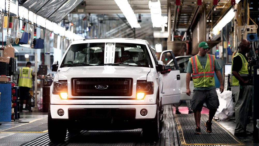 Ford F-150 trucks are prepared to come off the assembly line at the Ford Dearborn Truck Plant on June 13, 2014 in Dearborn, Mich.