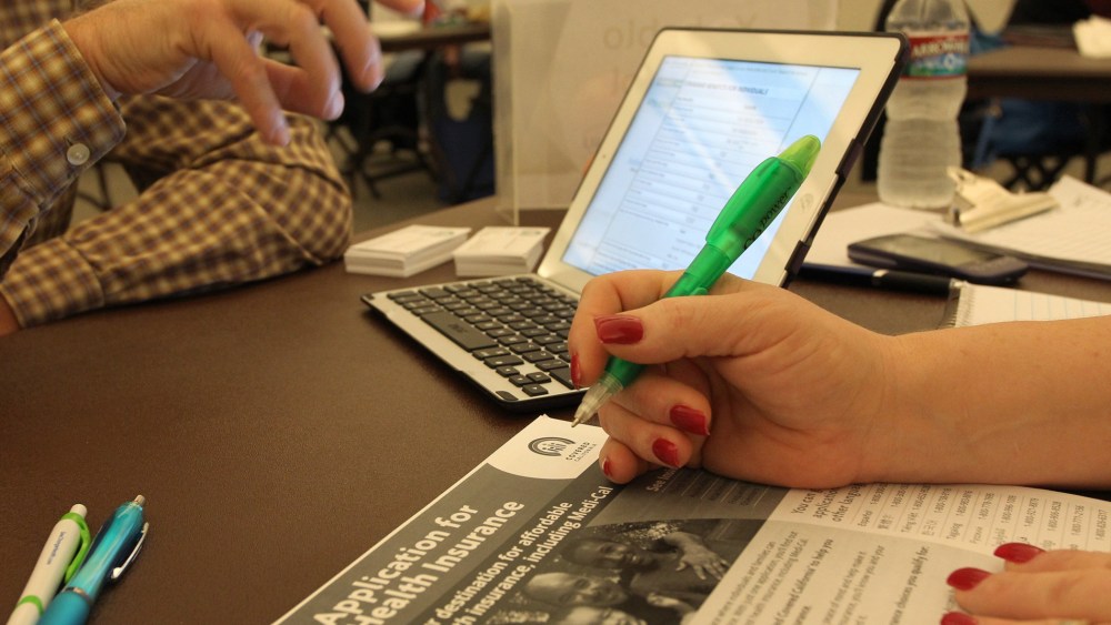 A healthcare reform specialist helps people select insurance plans at the free Affordable Care Act (ACA) Enrollment Fair at Pasadena City College on November 19, 2013 in Pasadena, California.