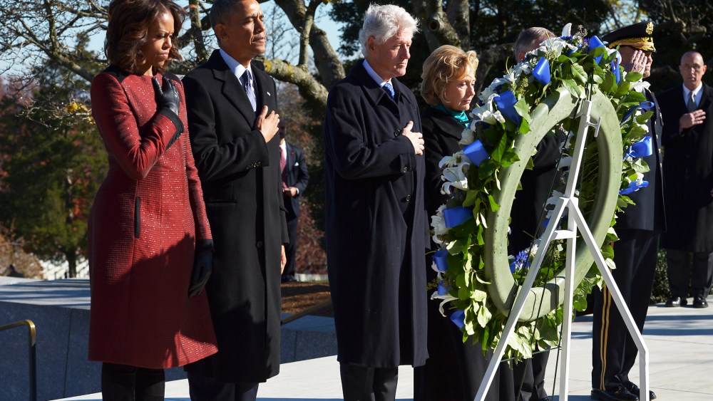 US President Barack Obama and Michelle Obama stand with the Clintons at a wreath-laying ceremony in honor of the late John F. Kennedy in Arlington, Virginia, Nov. 20, 2013.