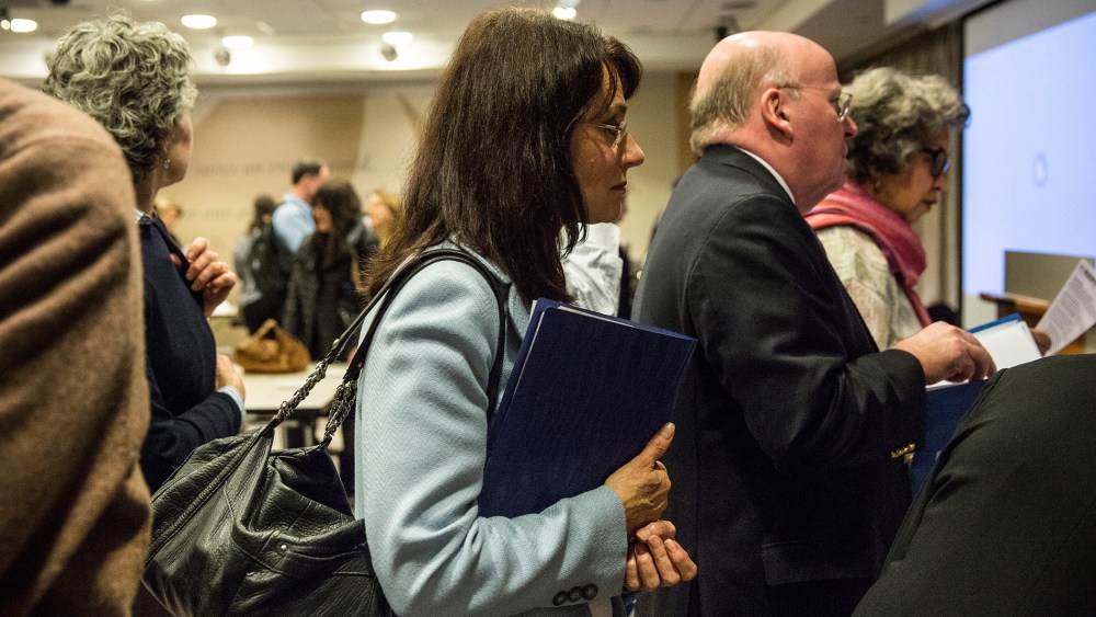 A woman prepares to speak to potential employers at a jobs fair in New York, Nov. 20, 2013.