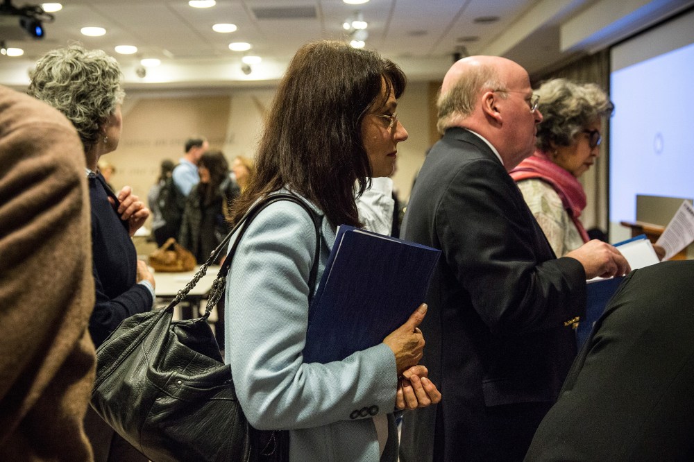A woman prepares to speak to potential employers at a jobs fair in New York, Nov. 20, 2013.