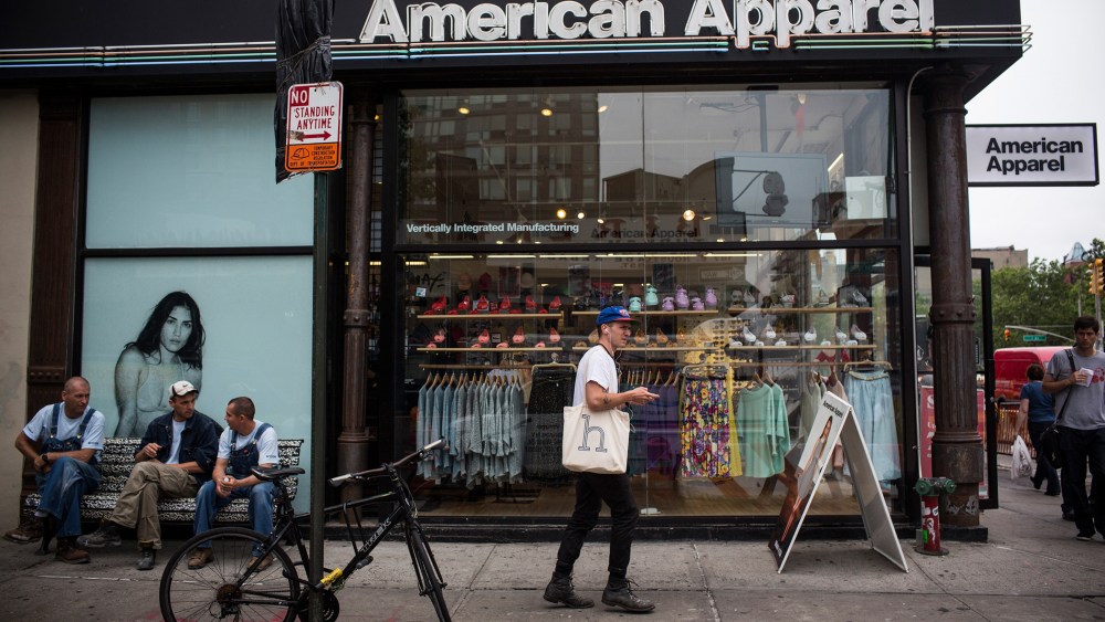 People walk past an American Apparel store on June 19, 2014 in New York City.
