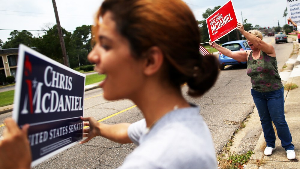 Supporters of Republican candidate for U.S. Senate, Mississippi State Sen. Chris McDaniel hold signs during a Tea Party Express campaign event in Biloxi, Mississippi, June 22, 2014.