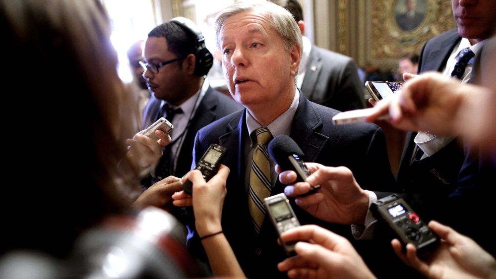Sen. Lindsey Graham (R-SC) talks with reporters after stepping off the Senate floor at the U.S. Capitol Nov. 21, 2013 in Washington, DC.