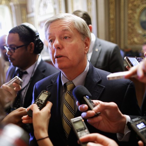 Sen. Lindsey Graham talks with reporters after stepping off the Senate floor at the U.S. Capitol, Nov. 21, 2013.