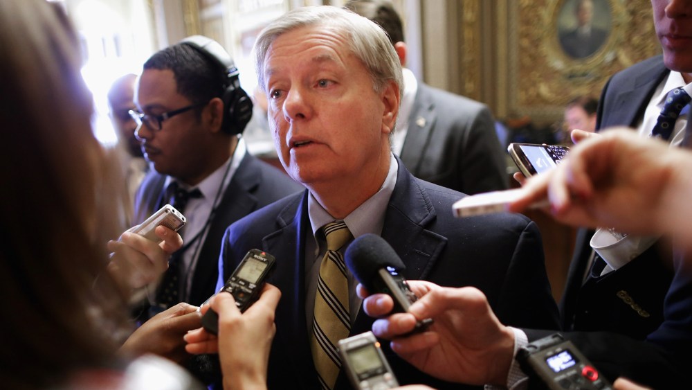 Sen. Lindsey Graham talks with reporters after stepping off the Senate floor at the U.S. Capitol, Nov. 21, 2013.