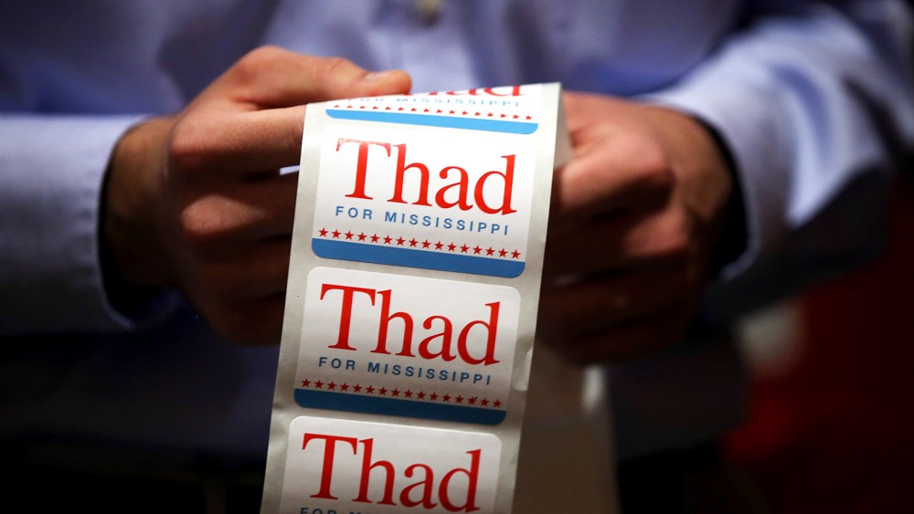 A campaign worker for U.S. Sen Thad Cochran (R-MS) passes out campaign stickers on June 23, 2014 in Jackson, Mississippi.