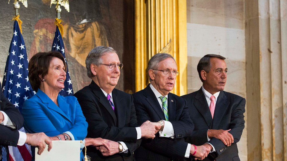 Lawmakers lock arms as they sing 'We Shall Overcome' during a ceremony to posthumously award the Congressional Gold Medal Dr. Martin Luther King, Jr. and Coretta Scott King, on Capitol Hill, June 24, 2014.
