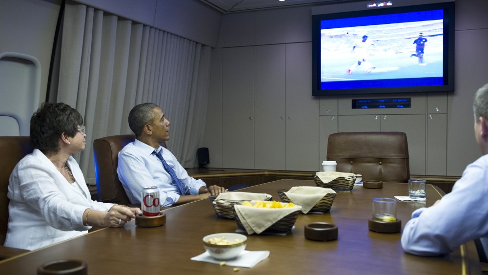 US President Barack Obama and Senior Advisor Valerie Jarrett (L) watch the 2014 World Cup match between the US and Germany while en route to Minnepolis, Minnesota on June 26, 2014.