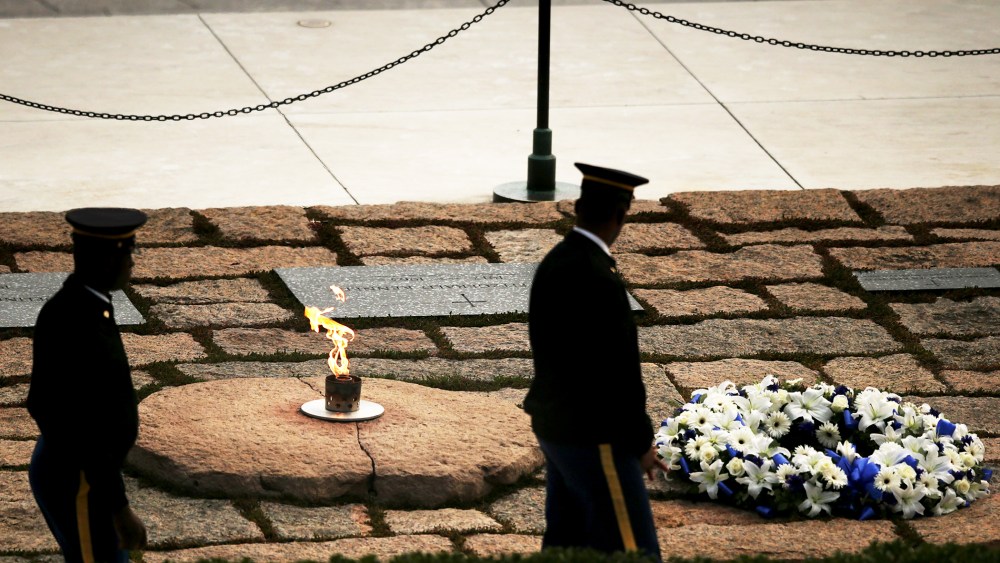 Members of the armed forces perform a walk-through at the gravesite of former U.S. President John F. Kennedy at Arlington National Cemetery, Nov. 22, 2013.