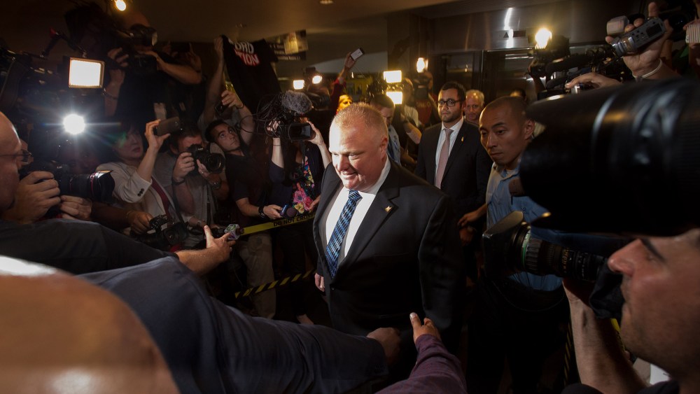 Toronto Mayor Rob Ford arrives at his office at city hall in Toronto on June 30, 2014 amid a crush of cameras.