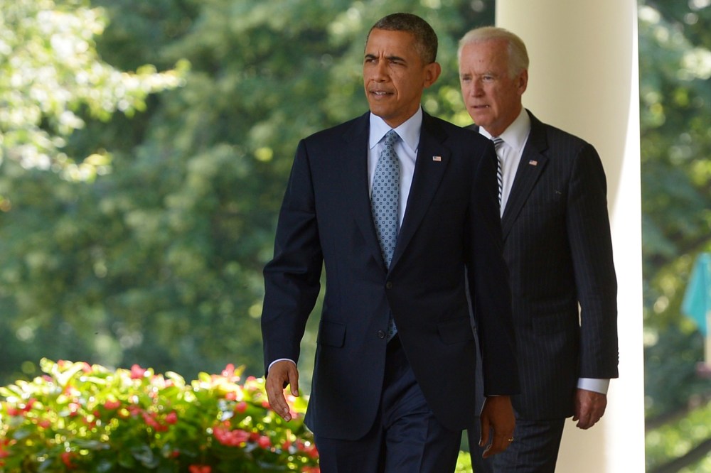 US President Barack Obama and Vice President Joe Biden make their way to the Rose Garden to speaks on immigration reform on June 30, 2014 at the White House in Washington, DC.