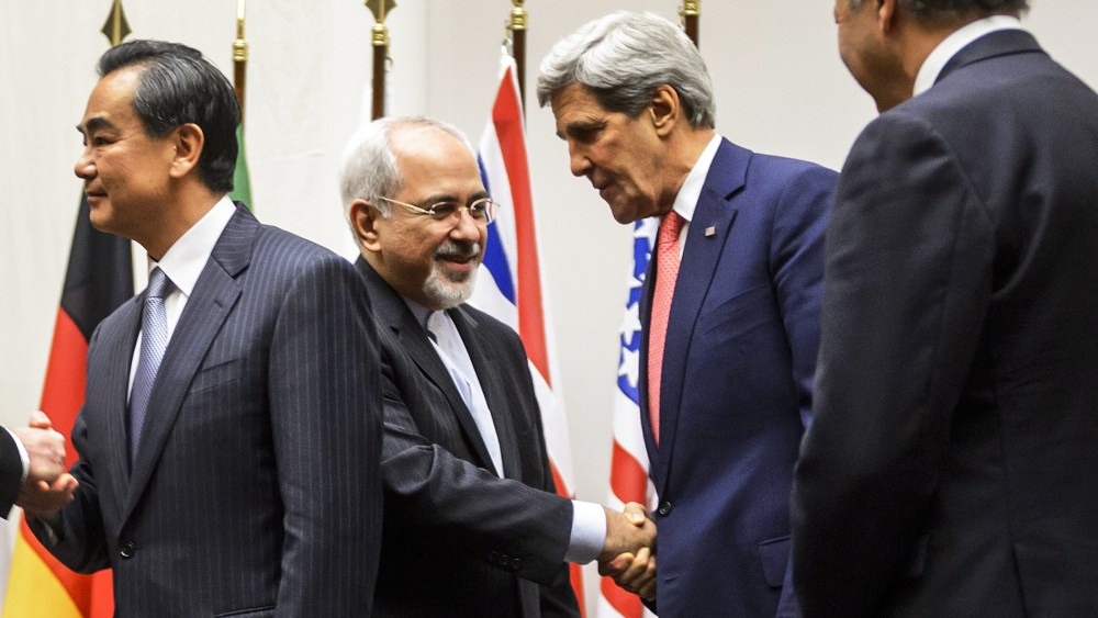 Iranian Foreign Minister Mohammad Javad Zarif shakes hands with US Secretary of State John Kerry, Nov. 24, 2013.