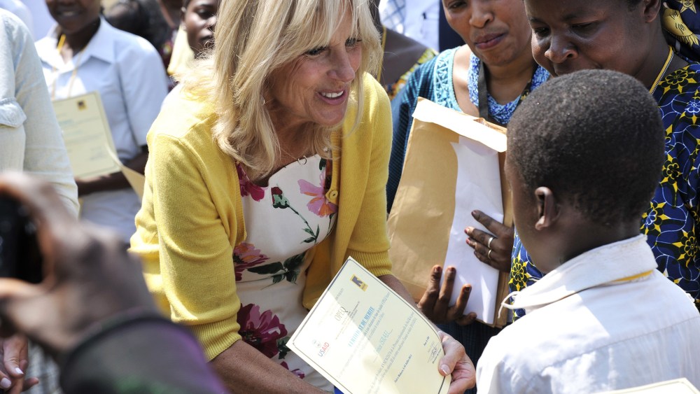 Dr. Jill Biden, wife of the US vice-president, hands a diploma to a student as representatives of the Anunciata non-governmental organization (NGO) look on, after she arrived at the airport of Bukavu, in eastern Democratic Republic of Congo, on July 5, 20