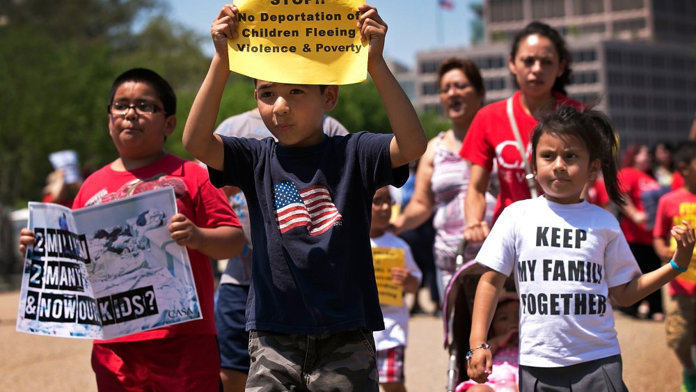 Young children join immigration reform protesters while marching in front of the White House July 7, 2014 in Washington, DC.