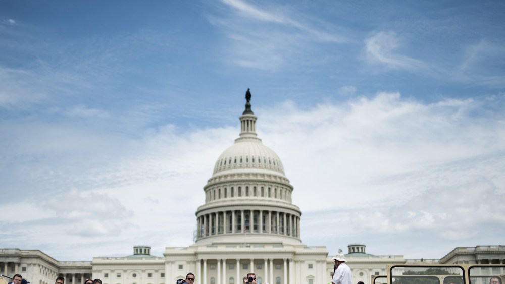 Tourists pass the US Capitol building on a bus, July 19, 2014 in Washington, DC.