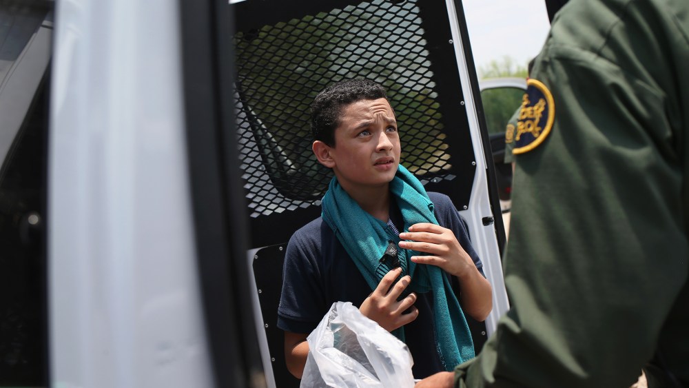 A U.S. Border Patrol agent prepares to take an unaccompanied Salvadorian minor, 13, to a processing center after he crossed the Rio Grande from Mexico into the United States on July 24, 2014 in Mission, Texas.