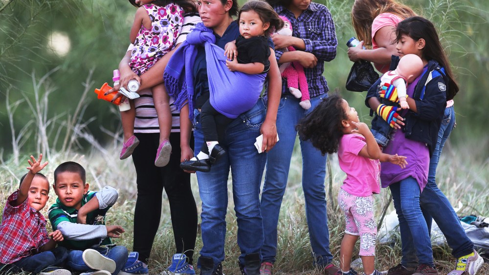 Central American immigrants await transportation to a U.S. Border Patrol processing center after crossing the Rio Grande from Mexico into the Texas on July 24, 2014 near Mission, Texas.