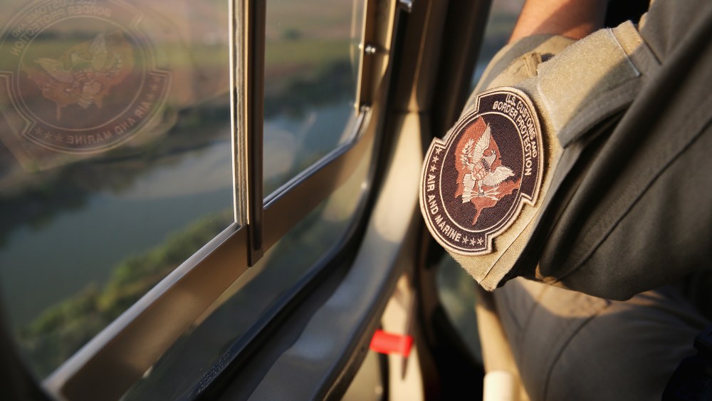 Pilots from the U.S. Office of Air and Marine patrol over the Rio Grande River on July 25, 2014 near Mission, Texas.