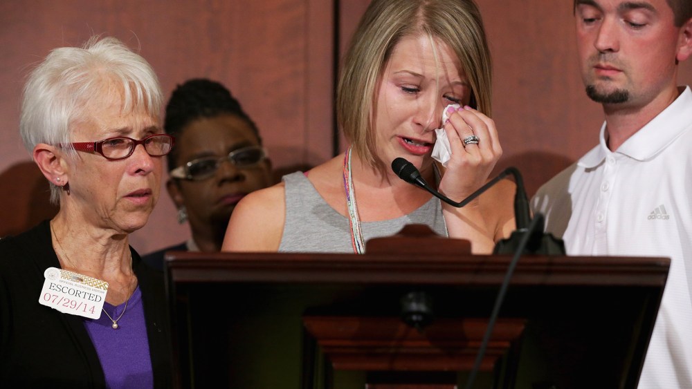 Kacey Mason (C) delivers remarks with her mother Merry Jackson (L), 63, and her husband Dave Mason during a news conference announcing new domestic violence legislation at the U.S. Capitol July 29, 2014 in Washington, DC.