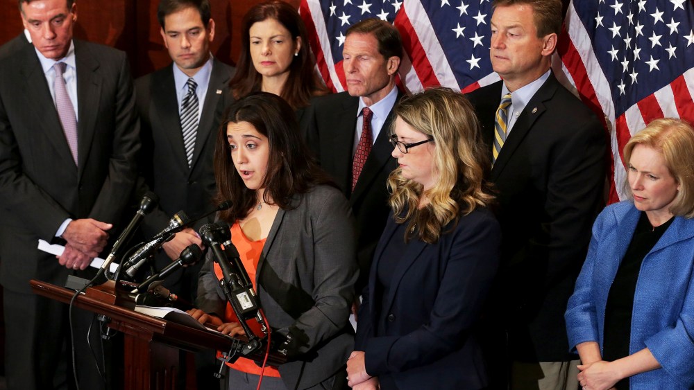End Rape on Campus co-founders Andrea Pino and Annie Clark are joined by (L-R) Sen. Mark Warner (D-VA), Sen. Marco Rubio (R-VL), Sen. Kelly Ayotte (R-NH), Sen. Richard Blumenthal (D-CT), Sen. Dean Heller (R-NV) and Sen. Kirsten Gillibrand (D-NY) during a
