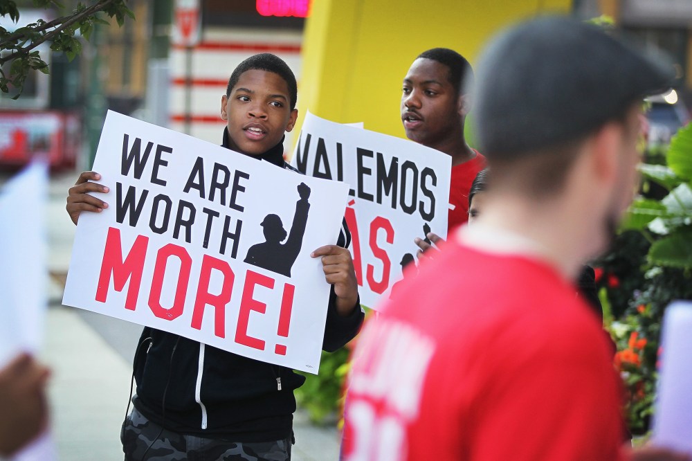 Fast food workers and activists demonstrate outside McDonald's downtown flagship restaurant on July 31, 2014 in Chicago, Ill.
