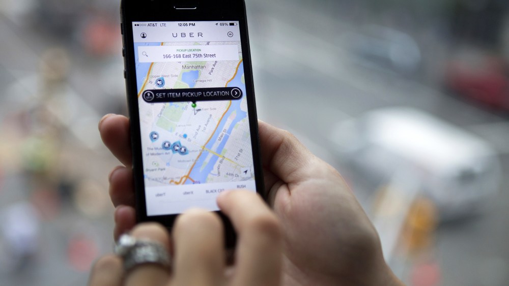 Th Uber Technologies Inc. car service application is demonstrated for a photograph on an iPhone in New York, N.Y., on Aug. 6, 2014. (Photo by Victor J. Blue/Bloomberg/Getty)